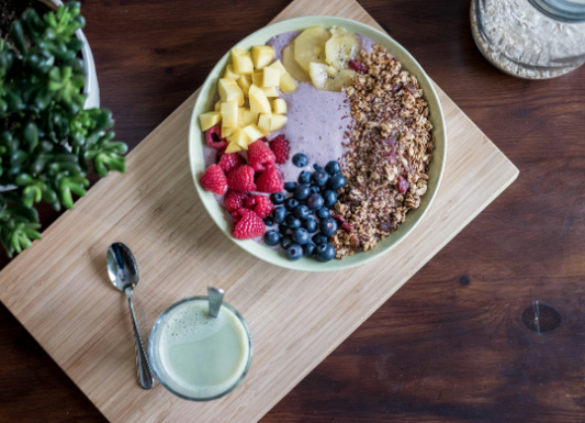 Healthy breakfast bowl with oats, berries, seeds, and a daily nutritional blend
